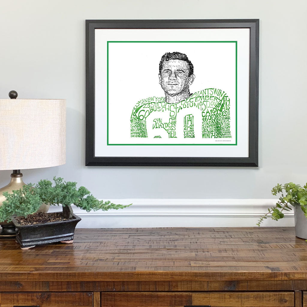  Matted and framed wall word art print of 1960 Philadelphia Eagle Chuck Bednarik hangs on wall over wooden table.